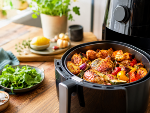 Air fryer roasted chicken, potatoes and vegetables prepared for easy weeknight meals